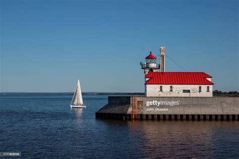 Lake Superior Lighthouse With Sailboat High-Res Stock Photo - Getty Images