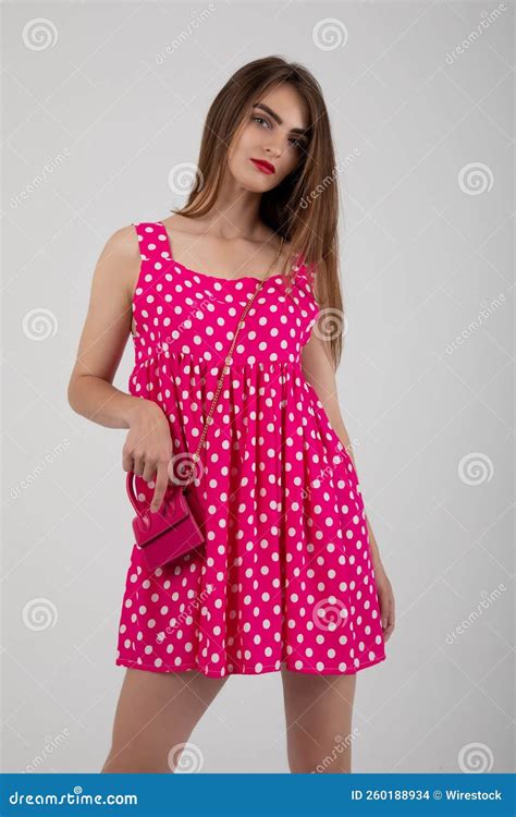 Stunning Model Posing In A Pink Polka Dot Mini Dress Stock Photo