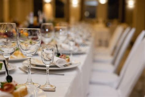 Elegant Dinner Table Setting In Restaurant Or Hotel With Wine Glasses