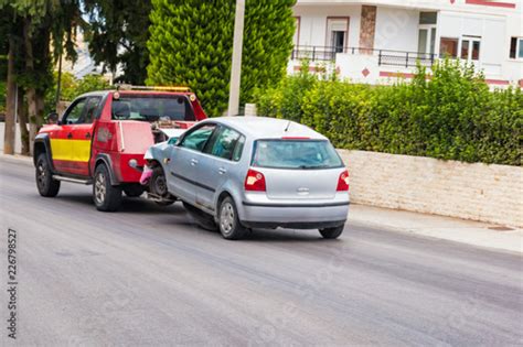 Crashed car being towed away by tow truck after accident Stock Photo | Adobe Stock