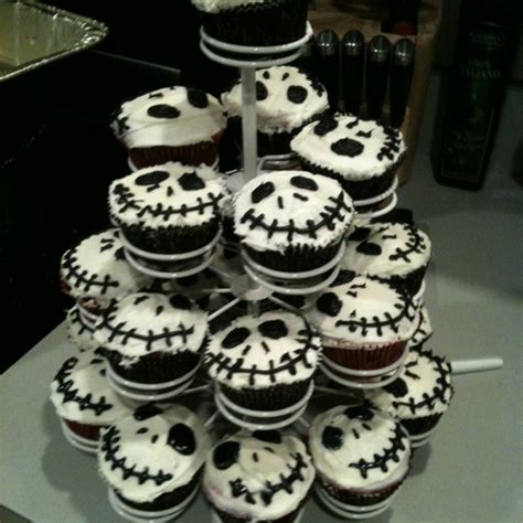 A Tower Of Cupcakes Decorated With Black And White Frosting Sprinkled