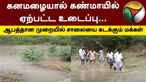 கனமழையால் கண்மாயில் ஏற்பட்ட உடைப்பு ஆபத்தான முறையில் சாலையை கடக்கும்