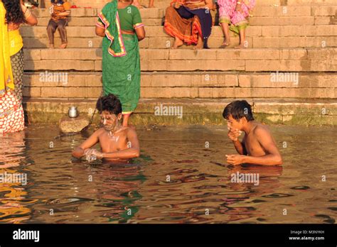 Devotees On The Banks Of The River Ganges Take A Holy Dip In Varanasi