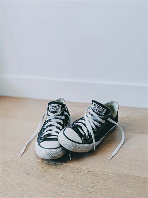 Converse All Star Low Top Sneakers On Brown Wooden Surface · Free Stock