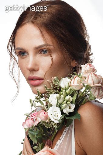 Beautiful Woman With Classic Nude Make Up Light Hairstyle And Flowers