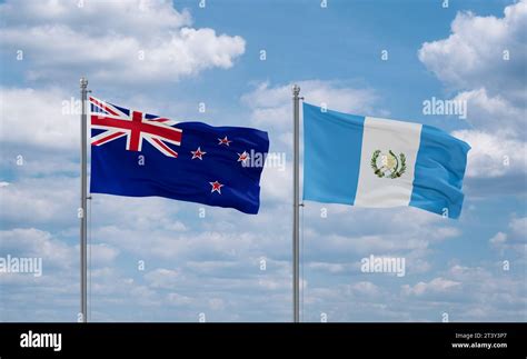 Guatemala And New Zealand Flags Waving Together On Blue Cloudy Sky Two