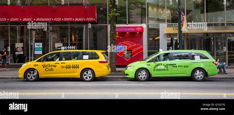 Charlotte North Carolina A Yellow Cab And A Green Cab Wait For Fares