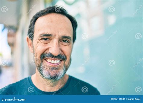 Middle Age Man With Beard Smiling Happy Outdoors Leaning On The Wall