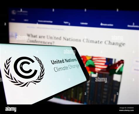 Cellphone With Logo Of United Nations Environmental Treaty Unfccc On Screen In Front Of Website