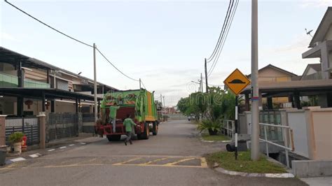 Waste Collection Garbage Truck And Workers Collecting Rubbish In The