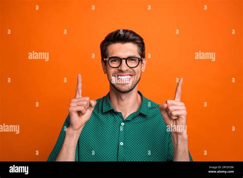 Photo Of Handsome Cool Guy Wear Green Shirt Typing Pointing Two Fingers Up Empty Space Isolated