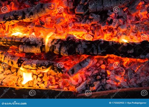 Closeup Of Glowing Log Embers And Flames Creating A Fiery Abstract