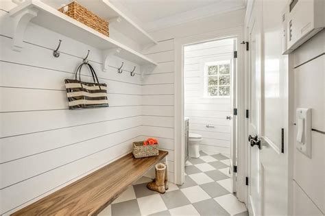 Cottage Style Mudroom With Shiplap Walls And A Long Wooden Bench