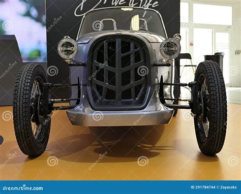 Front View Of Silver Electric Version Of Stylish Microcar Roadster