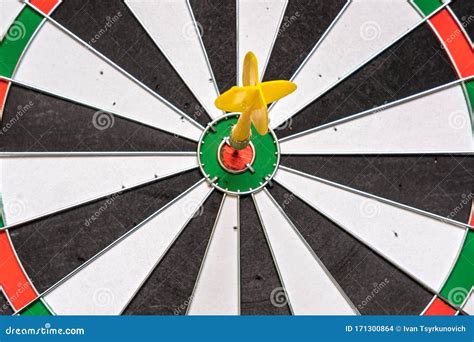 Red And Yellow Dart Arrows Hitting In The Target Center Of Dartboard