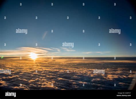 sunset seen from airplane, flying above clouds Stock Photo - Alamy