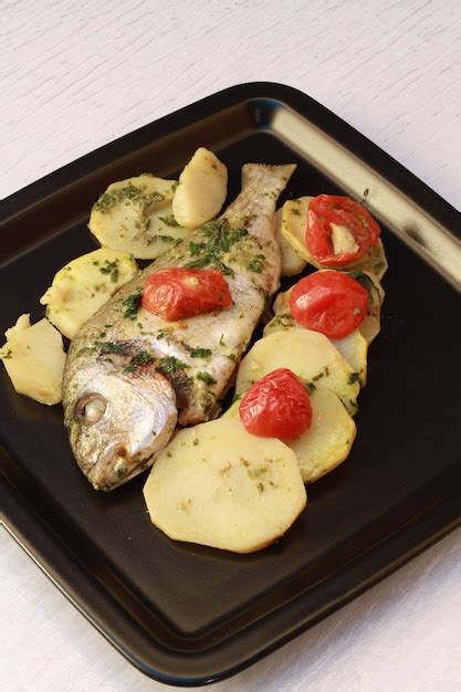 Premium Photo Baked Sea Bream With Potatoes