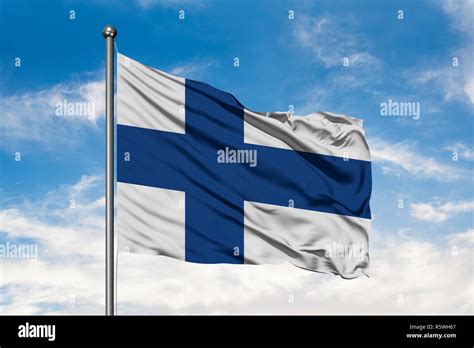 Flag Of Finland Waving In The Wind Against White Cloudy Blue Sky