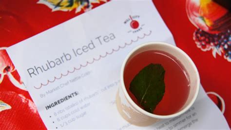 A Cup Of Tea Sitting On Top Of A Red Table Cloth Next To A Menu