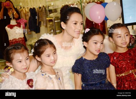 Chinese actress Zhang Ziyi, center, poses with young kids during the opening ceremony for the ...