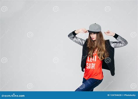 Swag Stylish Teenage Girl In Cap Posing With Hands Up Stock Photo