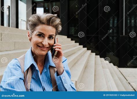 Mature Grey Woman Laughing While Talking On Mobile Phone Stock Image