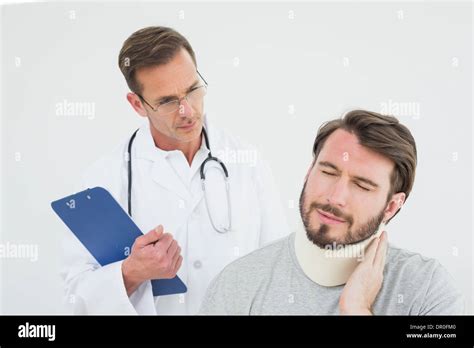 Male Doctor Examining A Patients Sprained Neck Stock Photo Alamy