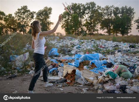 young girl throwing rubbish stock photo  olegkrugllyak