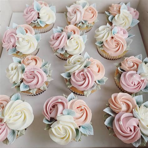 Cupcakes With Pink And White Frosting In A Box