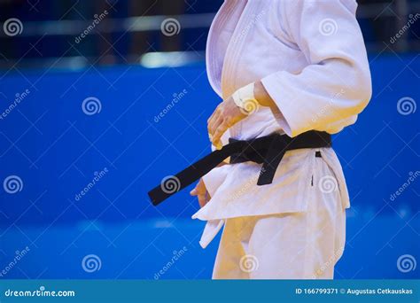 Judo Fighter Poses in White Kimono with Black Belt. Japanese Judo and ...