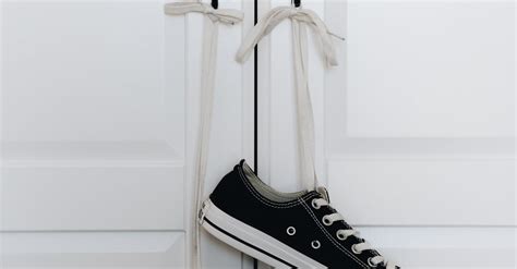 Sneakers Hanging By Its Laces On The Door Handle · Free Stock Photo
