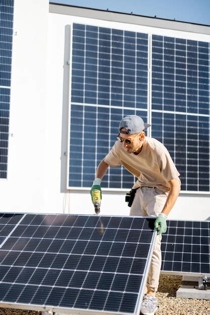 Premium Photo Man Installing Solar Panels On The Roof Of His House