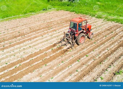 Farmer In Tractor Preparing Land With Seedbed Cultivator Aerial View