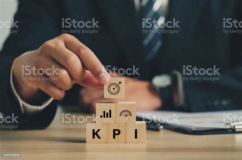 Key Performance Indicator Businessmen Arrange Wood Cubes With Kpi Icons