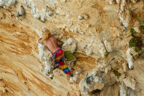 Sport Rock Climber Man With Colorful Hair On Challenging Overhanging