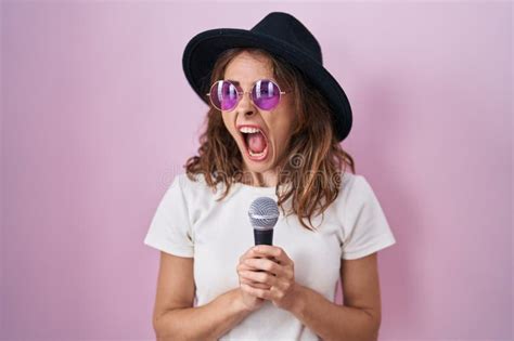 Beautiful Brunette Woman Singing Song Using Microphone Angry And Mad