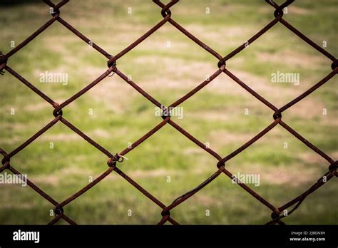 The Close Up Of Brown Wire Fence Barricade Which Is Hardly Rusted In