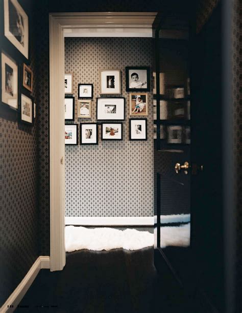 An Open Door Leading Into A Room With Pictures On The Wall And Framed