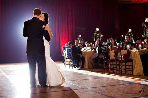 A Bride And Groom Sharing Their First Dance At Their Wedding Reception