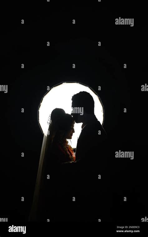 Couple Wedding Photoshoot In Dark Background Standing Forehead Kissing