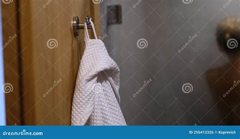 Naked Woman Is Washing In Shower And White Bathrobe On Hook Stock