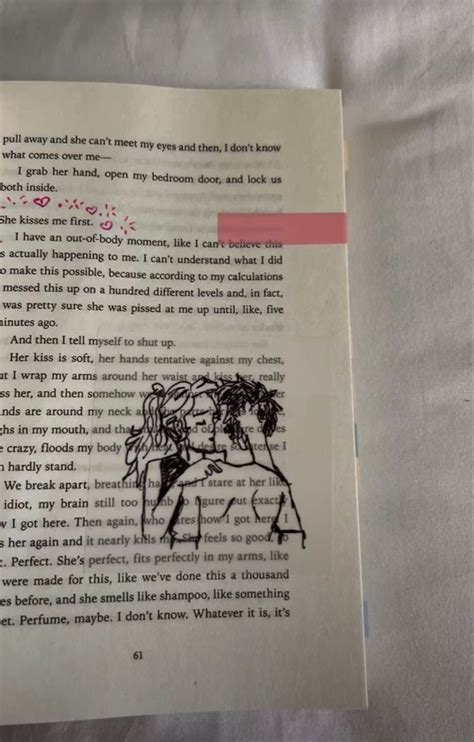 An Open Book With A Drawing Of A Man And Woman Kissing Each Other On It