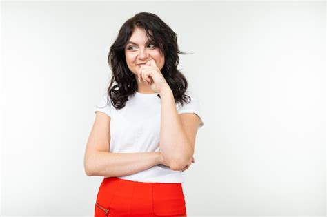 Premium Photo Attractive Brunette In A White T Shirt And Red Trousers Isolated On A White