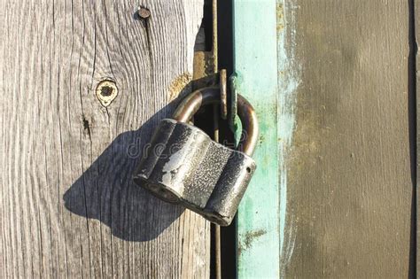 The Lock On The Door Of The Barn And The Texture Of Wood And Metal