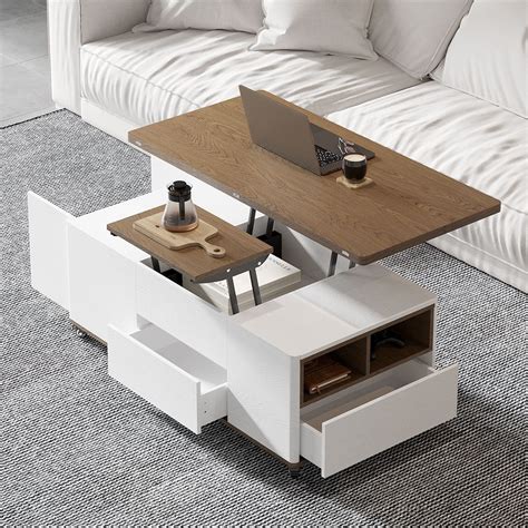 A White Coffee Table With A Laptop On Top And Drawers Underneath It In