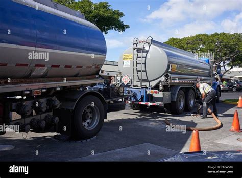 A tanker truck driver delivers gasoline to a gas station in Kailua-Kona on the Big Island ...