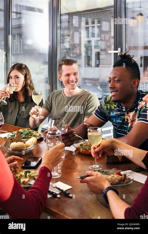 Group Of Friends Enjoying Meal In Restaurant Stock Photo Alamy