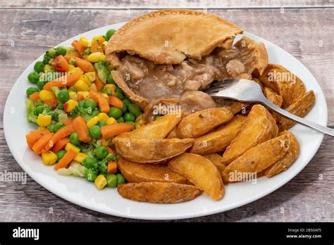 Chicken pie with vegetables and potato fries with gravy Stock Photo - Alamy