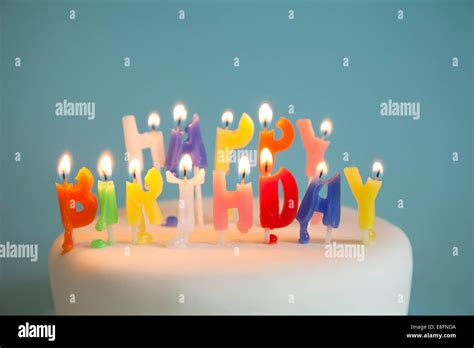 Lit Happy Birthday Candles On A Birthday Cake Stock Photo Alamy