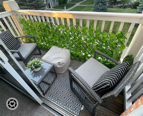 The Balcony Is Decorated With Black And White Furniture